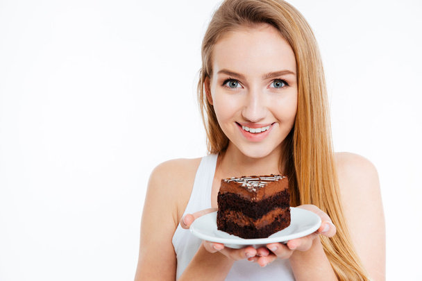 Happy pretty woman holding piece of chocolate cake on plate - Photo, image