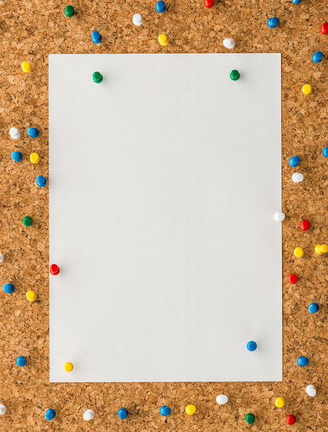 white paper note sheet with blue push pin on cork board  - Photo, Image