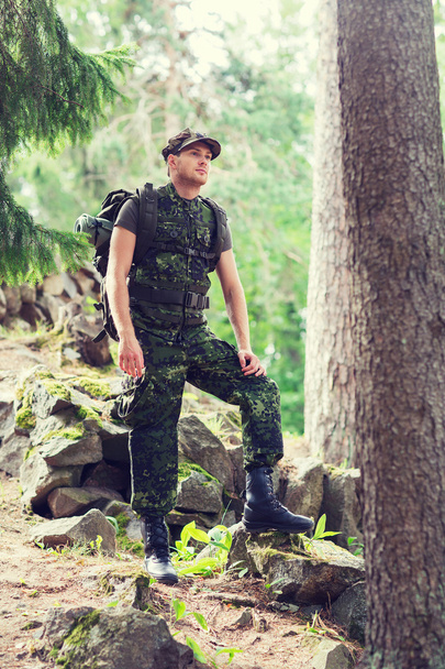 young soldier with backpack in forest - 写真・画像