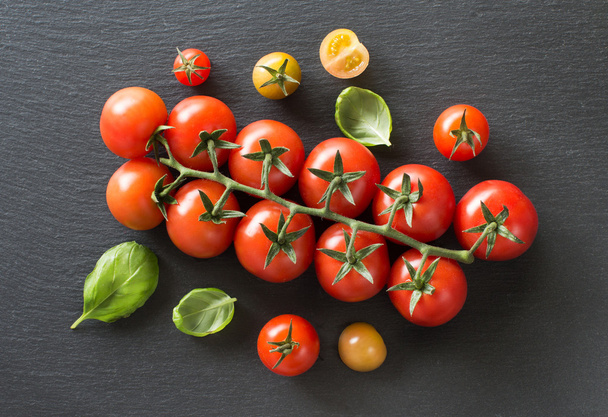 Fresh cherry tomatoes and basil top view - Fotoğraf, Görsel