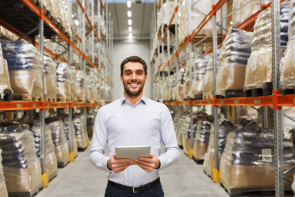 happy businessman with tablet pc at warehouse - Foto, immagini
