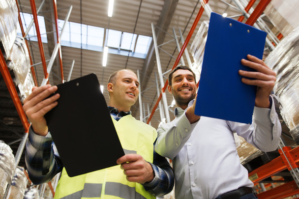 worker and businessmen with clipboard at warehouse - Photo, Image
