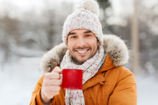 happy man with tea cup outdoors in winter - Foto, Imagem