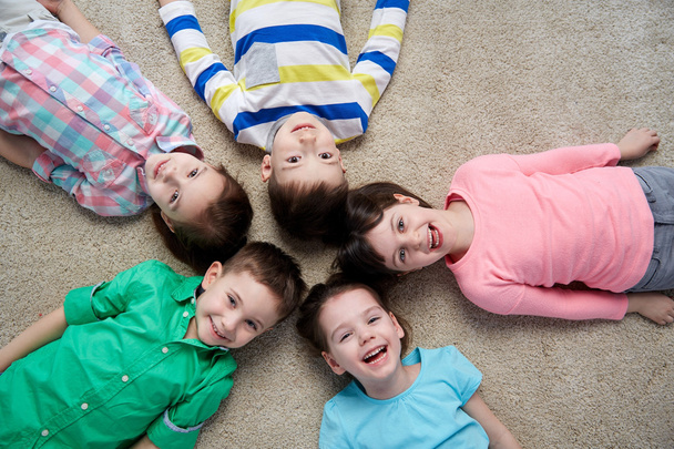 happy smiling little children lying on floor - Valokuva, kuva