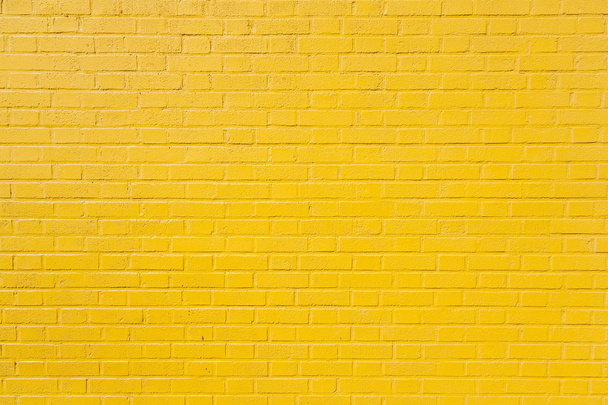 horizontal part of yellow painted brick wall - Foto, imagen