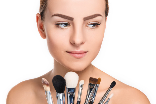 Beautiful female eyes with make-up and brushes - Фото, изображение