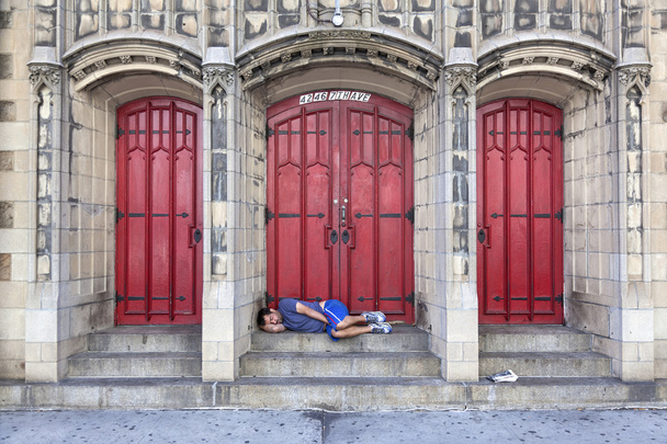 man sleeps in front of church door on 7th ave in new york city - Photo, image
