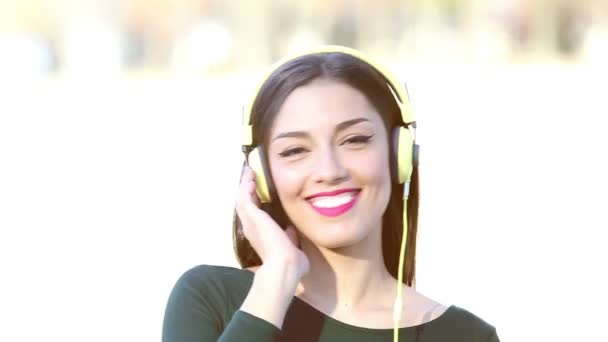 woman with headphones listening to music - Кадры, видео