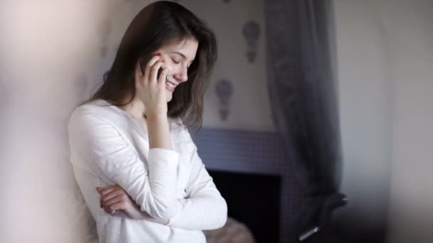 Young woman calling in her bedroom - Felvétel, videó