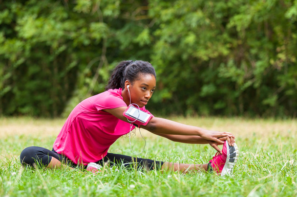  African american woman jogger stretching  - Fitness, people and - Fotó, kép