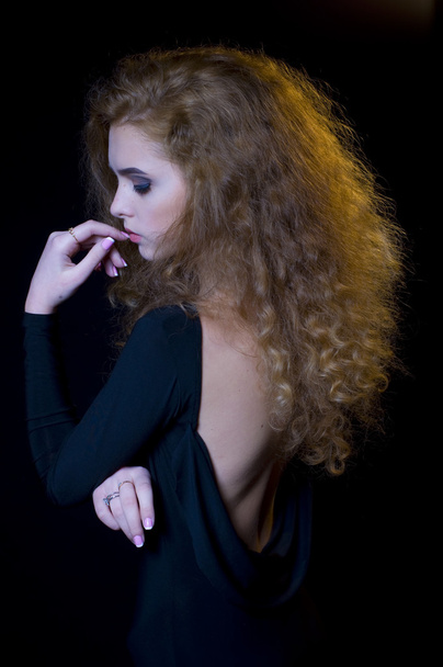 studio portrait of beautiful young model on black background - Valokuva, kuva