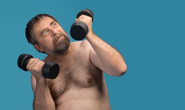 elderly fat man exercising with dumbbells - Photo, Image