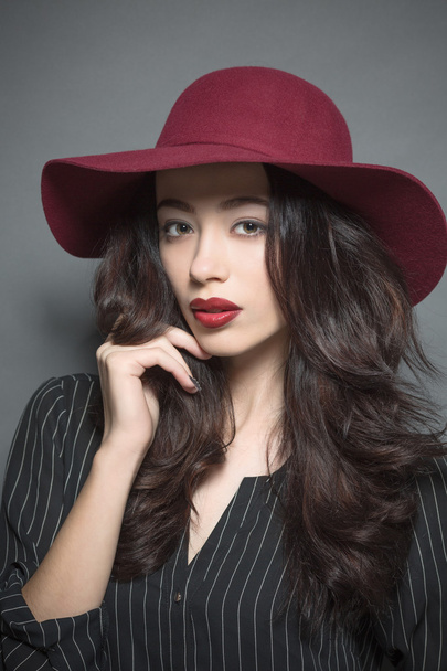Fashion model woman with dark red hat on - Фото, изображение