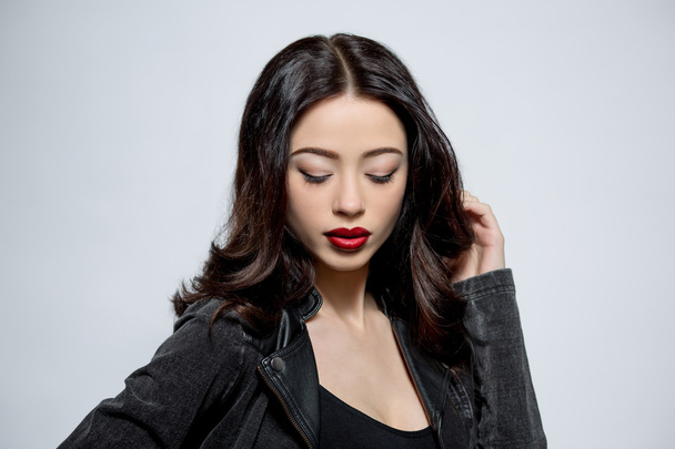 Fashion model woman with dark red lips in studio - Fotó, kép