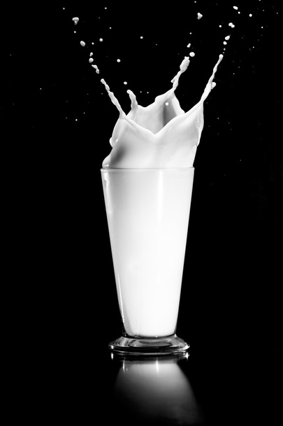 milk splash on black background - Foto, imagen