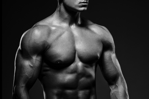 Close-up of a power fitness man. Strong and handsome young man - Photo, Image
