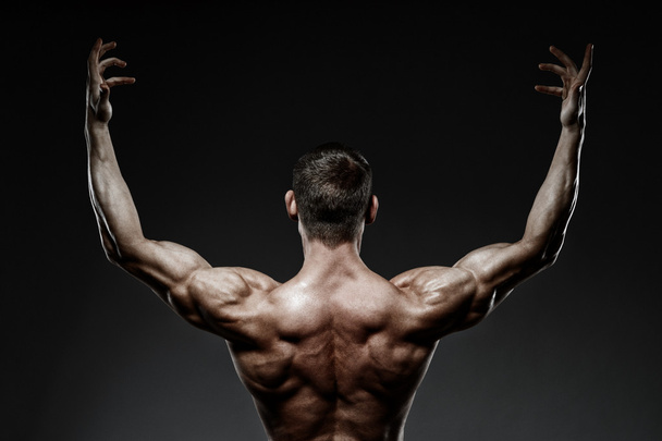 bodybuilder posing and turned his back - Photo, Image