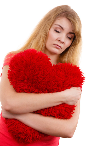 Woman  hugging red heart pillow - Foto, imagen