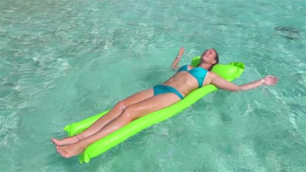 SLOW MOTION: Woman laying and relaxing on water airbed mattress - Video