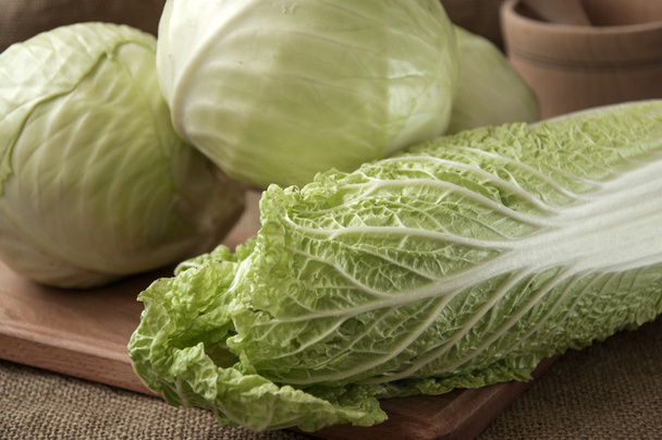 cabbage on a wooden board on a background sacking, burlap - Photo, image
