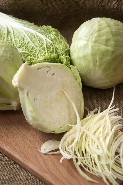 cabbage on a wooden board on a background sacking, burlap - Foto, Imagen