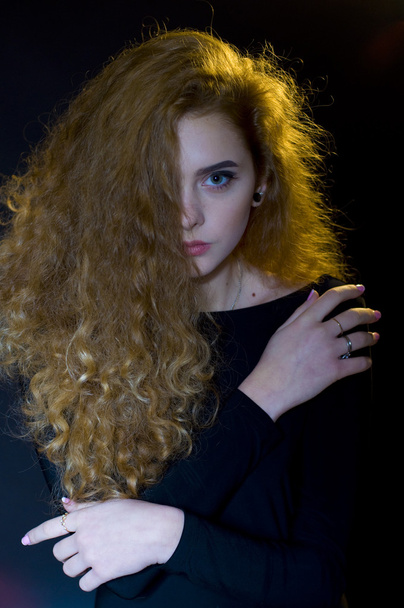 studio portrait of beautiful young model on black background - 写真・画像