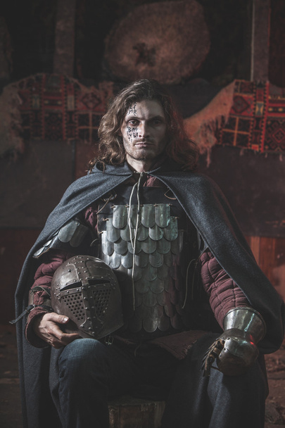 Long haired medieval knight in the armor - Photo, Image