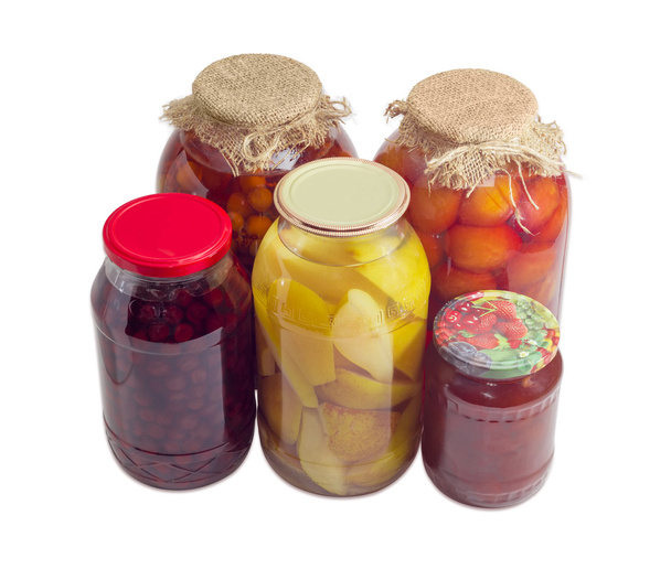 Консервированные фрукты в стеклянных банках на светлом фоне
 - Фото, изображение