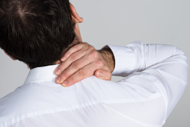 businessman suffering from neck ache - Фото, изображение