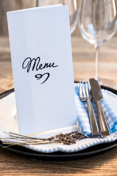 Restaurant table setting with menu and utensils - Photo, Image