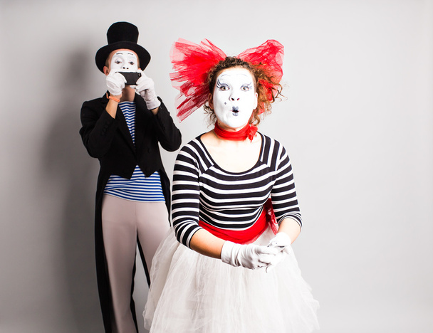 Funny couple of mimes taking a selfie photo on a mobile phone. Concept of  April Fools Day. - Photo, Image