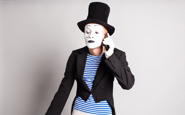 mime with smartphone. Concept of  April Fools Day. - Photo, Image