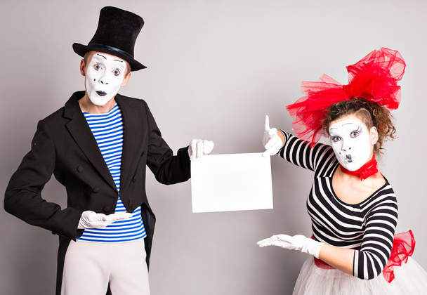 Twee mimespelers met een teken voor reclame, April Fools Day concept - Foto, afbeelding