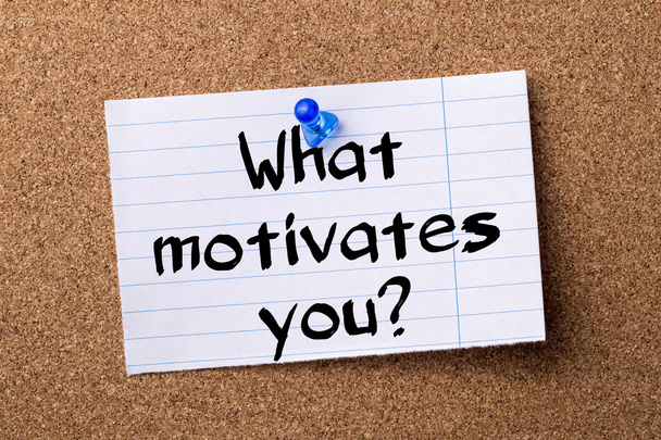 What motivates you? - teared note paper pinned on bulletin board - Zdjęcie, obraz