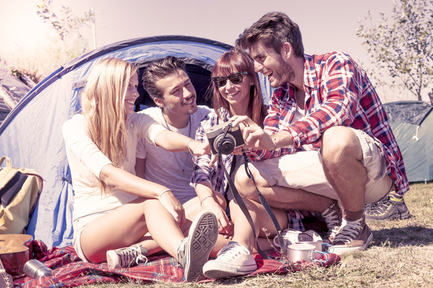group of young adult watching photos on digital camera - Foto, Bild