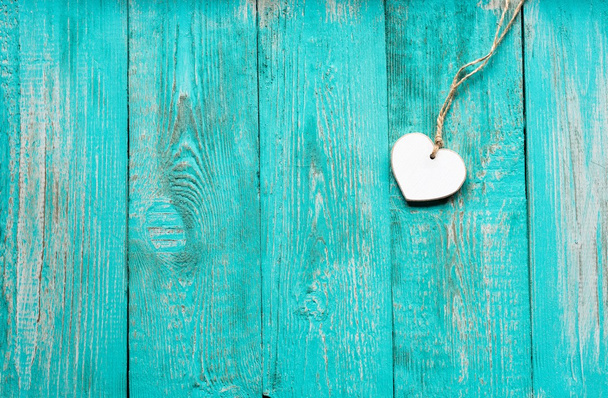 Old turquoise wooden floor with a white wooden heart - Photo, Image