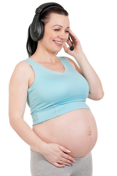 Pregnant with headphones - Фото, изображение