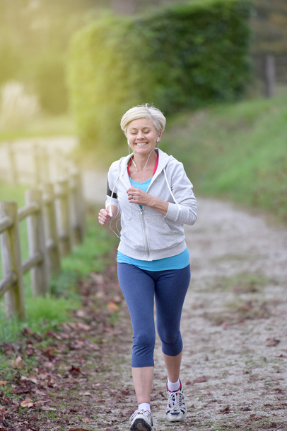 Senior woman jogging - Фото, зображення