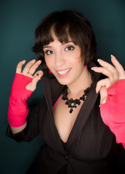 Picture of a young woman in jacket and pink gloves - Foto, afbeelding
