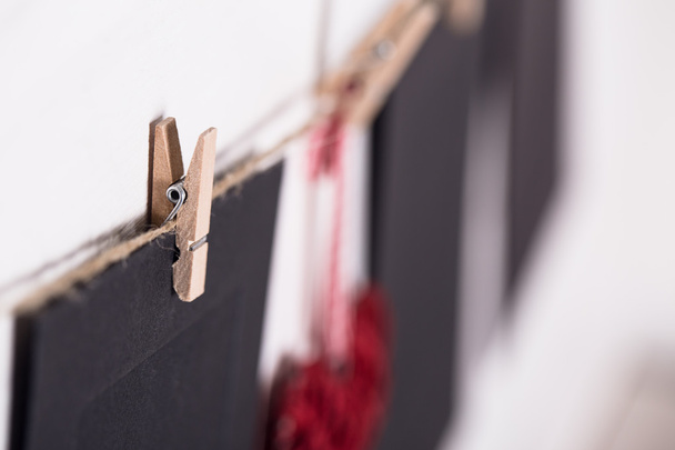 Cards and heart hanging on a rope hitched clothespins. - Photo, Image