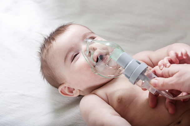 Doctor makes inhalation to a sick little baby. - Fotografie, Obrázek