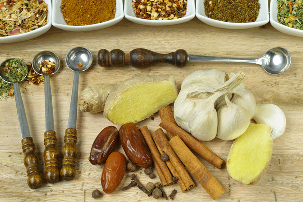 Set of spices and seasonings with vintage spoons on teak wood - Fotografie, Obrázek