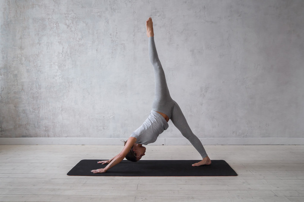 Woman practicing advanced yoga - 写真・画像
