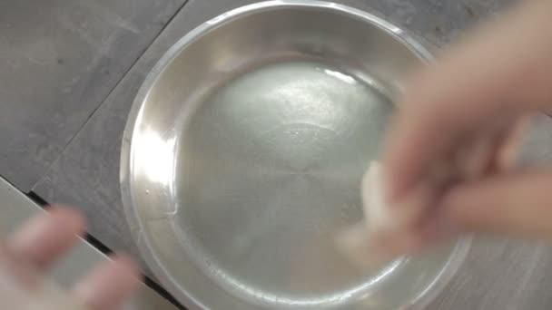 Three strips of bacon frying in a pan. - Video, Çekim