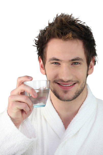 Young man with a glass of water - Photo, image