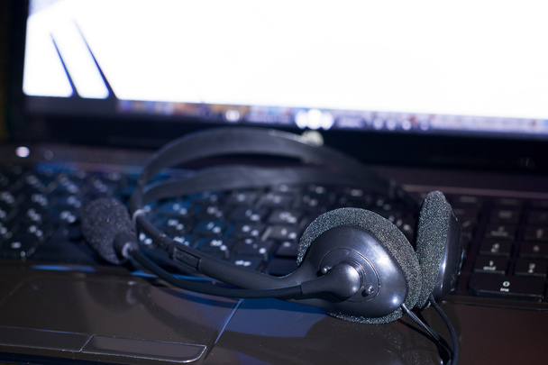 headset with microphone lie on a laptop - Photo, Image