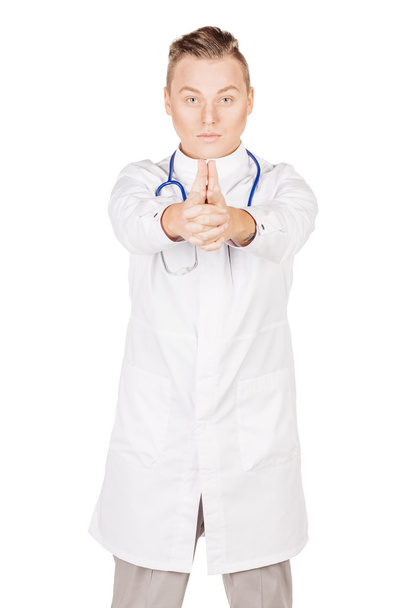 young male doctor in white coat imitating a pistol with her hand - Foto, immagini
