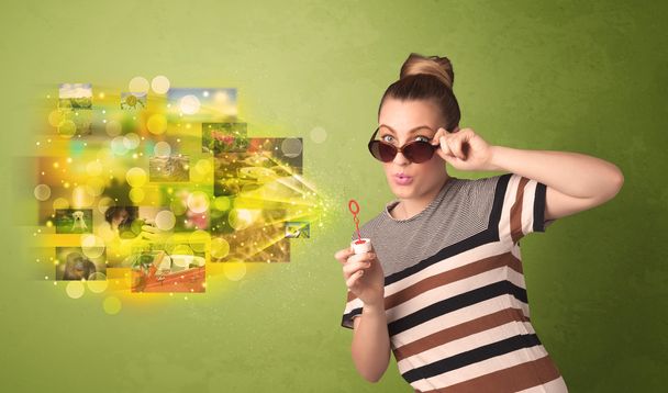 Cute girl blowing colourful glowing memory picture concept - Foto, immagini