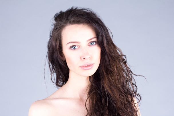 Beautiful and attractive woman with clean skin and wavy hair. - Fotó, kép