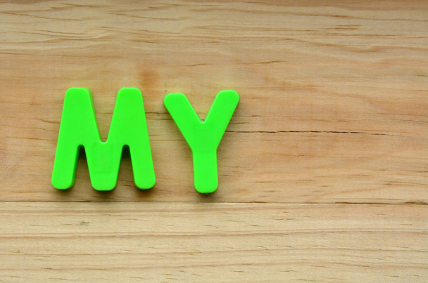 Top lay of the word My on a wooden background - Photo, Image